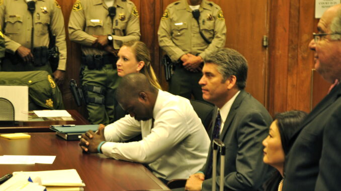 Fig 9_Brooks The moment Brian Banks is finally exonerated. From left: Alissa Bjerkhoel, Brian Banks, Justin Brooks. Photo credit: Heidi Brooks.
